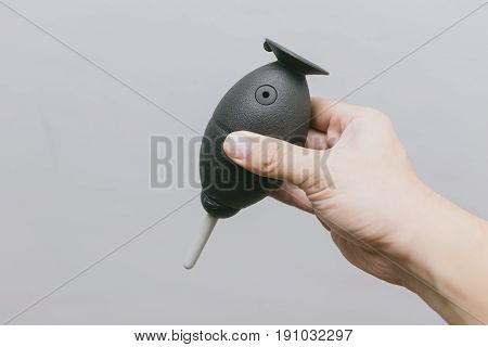 Male Hand Hold Camera Cleaning Tool Isolated On Gray Background, Manual Squeeze Air Blower For Blow