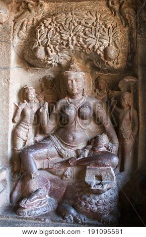 Durga Goddess with lion - ancient bas-relief in Ellora caves, India. Ellora is one of the largest rock-cut temple caves complexes in the world and a UNESCO World Heritage Site in Maharashtra state.