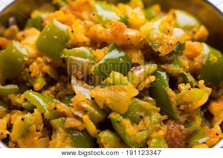 shimla mirch sabji or simla mirch sabzi or spicy capsicum indian food or vegetable recipe using lot of onion and chikpea flour