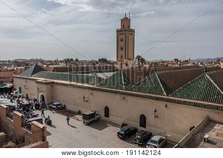 Marrakesh, Morocco - May 3, 2017: Roof and minaret of Mosque of Ben Youssef view from neighbors roof.