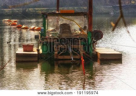 Dredger Floating excavator when dredging of soil sand and silt from a river.