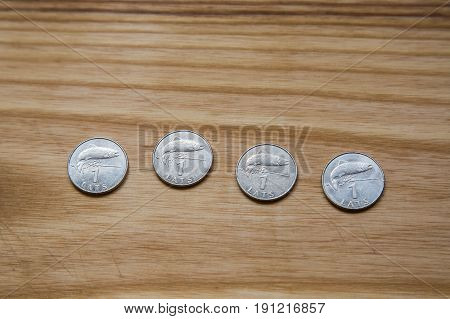 Old Latvian Coins On A Wooden Background