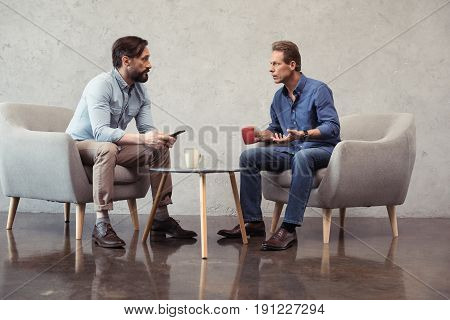 casual businessmen talking during meeting at coffee break