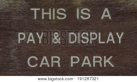 white letter Pay and Display car parking sign