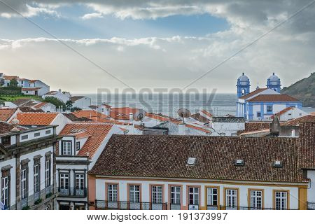 Wide view of church and roofs in Angra do Heroismo with atlantic ocean in the background, Island of Terceira in Azores, Portugal