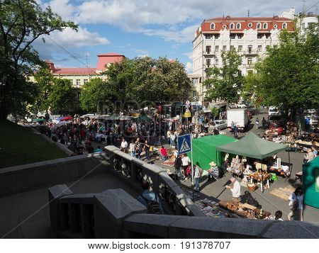 KIEV - UKRAINE - MAY, 2017: Many people are walking along Vladimirskaya Street on the Day of Kiev. Along the street there are souvenir shops with national Ukrainian goods.