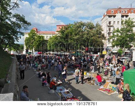 KIEV - UKRAINE - MAY, 2017: Many people are walking along Vladimirskaya Street on the Day of Kiev. Along the street there are souvenir shops with national Ukrainian goods.