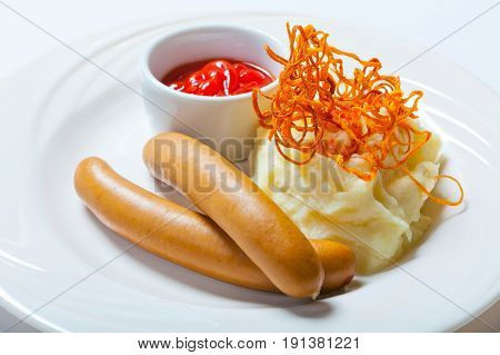 Mashed Potato And Sausages On The White Background