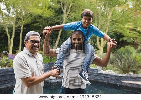 Portrait of happy multi-generation family enjoying together at park