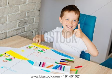 Child Draws Oil Pastel Drawing Of Family On The Beach.
