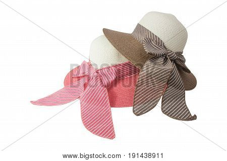 Woven hat with pink, beige and brown,beige, decorated with a pink bow tie, isolated on white background.