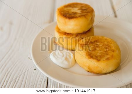 Close up freshly cooked Syrniki or cheesecakes for breakfast on plate