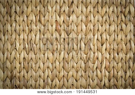Meshwork of woven reed wicker texture background with nice lighting and elegant vignetting to draw the attention.