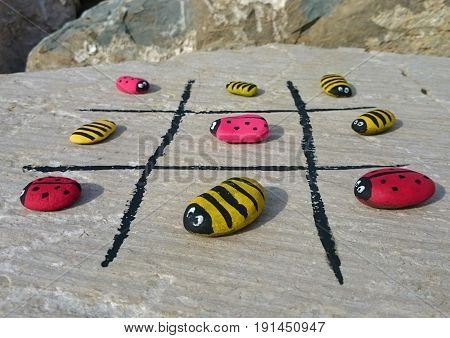 ladybugs and bees are painted on the rocks
