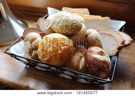 fresh rolls lying in a basket on table
