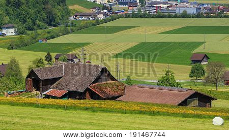 Mt. Stanserhorn, Switzerland - 8 May, 2016: buildings and fields at the foot of Mt. Stanserhorn. The Stanserhorn is a mountain in Switzerland, located in the Swiss canton of Nidwalden, close to its border with the canton of Obwalden.