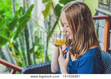 Young Beautiful Redhead Woman Sitting In A Cafe Drinking A Delicious Morning Ginger Tea In A Cafe