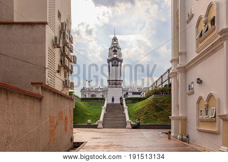 IPOH, PERAK, MALAYSIA - APRIL 14, 2017: Pedestrian walk at Old Town Ipoh with JWW Birch Memorial Clock Tower in background