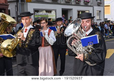 People Wearing Traditional Clothes And Playing Music Of Switzerland