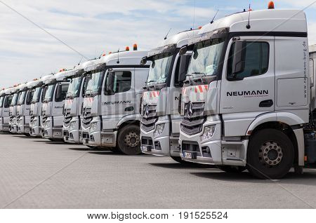 BURG / GERMANY - JUNE 11 2017: german Mercedes Benz Actros trucks from haulage firm Neumann stands in a row.