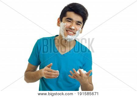 Portrait of a cheerful guy with beard foam isolated on a white background close-up