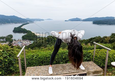 Woman upside down for viewing Amanohashidate in Kyoto