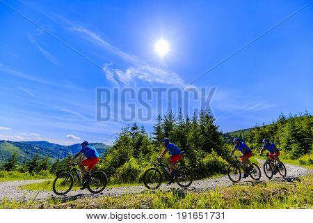 Mountain biker riding on bike in summer mountains forest landscape. Man cycling MTB flow trail track. Outdoor sport activity.Series of multi exposure