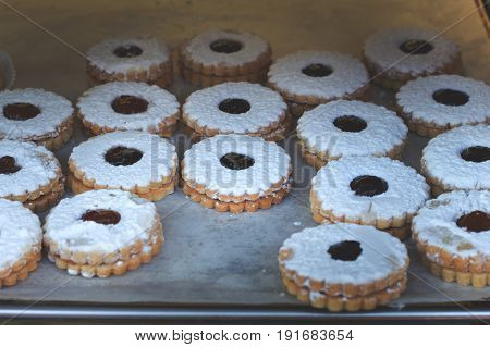 Cookies Covered With Sugar Powder And With Apple Jam For Sale On Market. Top View. Close-up