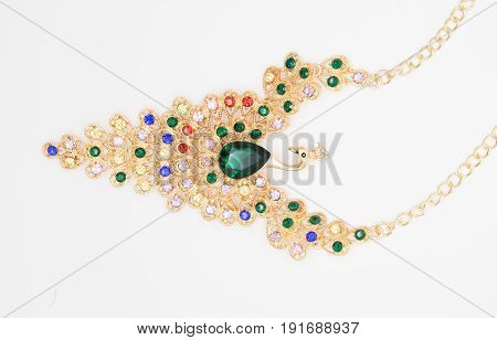 really precious necklace in the form of a bird with beautiful green and colourful stones the concept of fashion style
