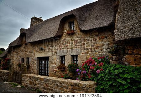 Village of Kerascoet, traditional stone houses with thatched roof in Brittany France