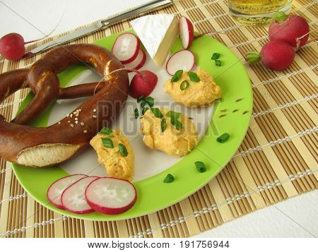Snack with homemade obatzda and lye bretzel