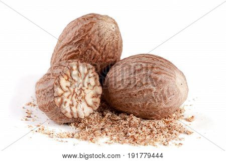 Three nutmeg and powder isolated on white background.