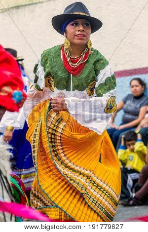 Banos De Agua Santa Ecuador - 29 November 2014:Indigenous woman dancer is dancing on the streets of Banos de Agua Santa South America Christmas Holiday On November 29 2014