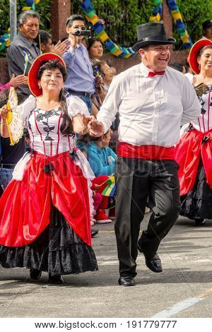 Banos De Agua Santa Ecuador - 29 November 2014: Group Of Latino People From Ecuador Dancing On The Streets Of Banos De Agua Santa South America On 29 November 2014