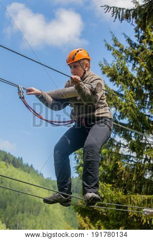 Romanian Adult Woman Wearing Casual Clothing On Zip-Line Canopy Experience In Retezat Mountains Romania