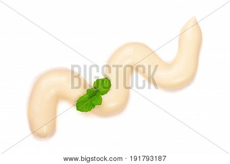 Mayonnaise with a mint leaf isolated on a white background close-up. Top view.