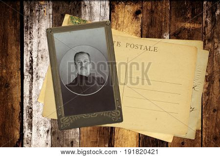 Vintage post cards and retro photo on old wooden planks. Inscription on the card - 