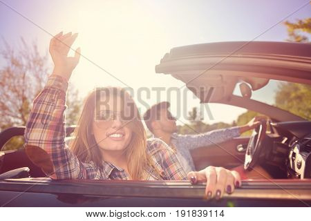 Couple of lovers driving on a convertible car - Newlywed pair on a romantic date.