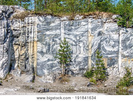 Marble quarry marble rocks in the wild in the Republic of Karelia Russia. The natural stone. Ancient Marble quarry marble rocks in the wild. Slices of marble mountain. Tourism and travel.
