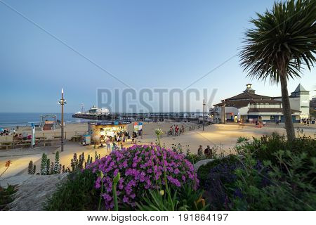 Bournemouth, UK. 17th June 2017. People are walking along the seafront by Bournemouth Pier and the beach.