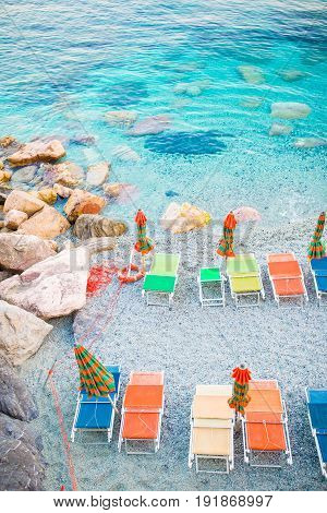 Empty beach with closed umbrellas on italian coast