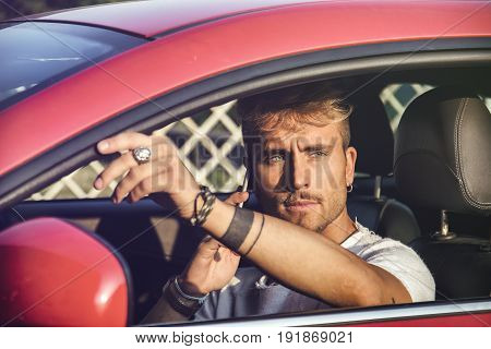 Inattentive Handsome Young Man Calling on Phone While Driving a Car.