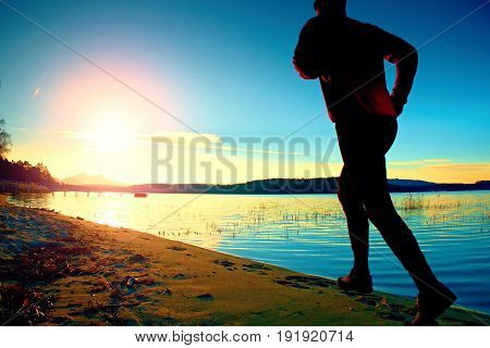 Sportsman Running At Amazing Summer Sunset Along Coastline In Sport And Healthy Life  Style