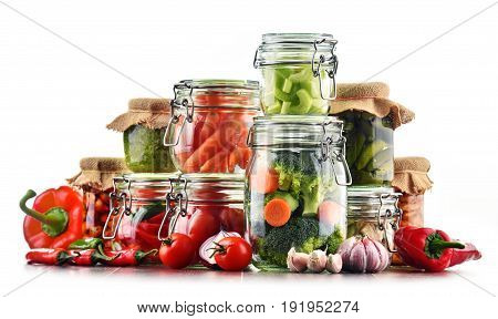 Jars With Marinated Food And Raw Vegetables Isolated On White