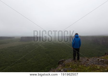 Solitude Landscape In Iceland Mist. Single Male Traveler Standing On The Cliff Of Famous Horseshoe N