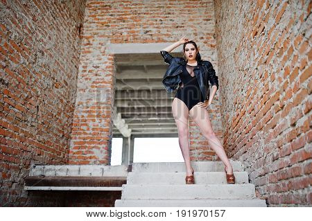 Brunette Plus Size Sexy Woman, Wear At Black One Piece And Leather Jacket, At Abadoned Place.
