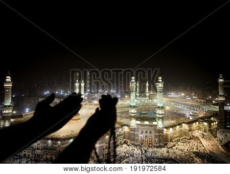 Muslim hands praying in Kaaba