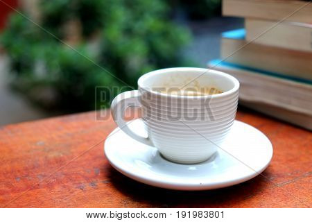 Espresso in the white cup with books