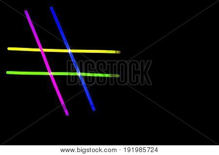 Glow sticks neon light fluorescent on back background. variation of different colored chem lights