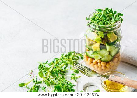 Green Salad With Chickpeas In A Jar, White Background, Copy Space. Detox, Vegan Food, Plant Based Di